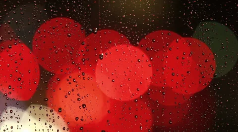 Rain drops on window with moving traffic light Video stock 35710888