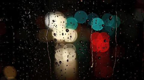 Rain drops on window with moving traffic light Stock Footage 35714188