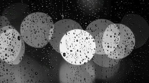 Rain drops on window with moving traffic light Stock Footage 35714304