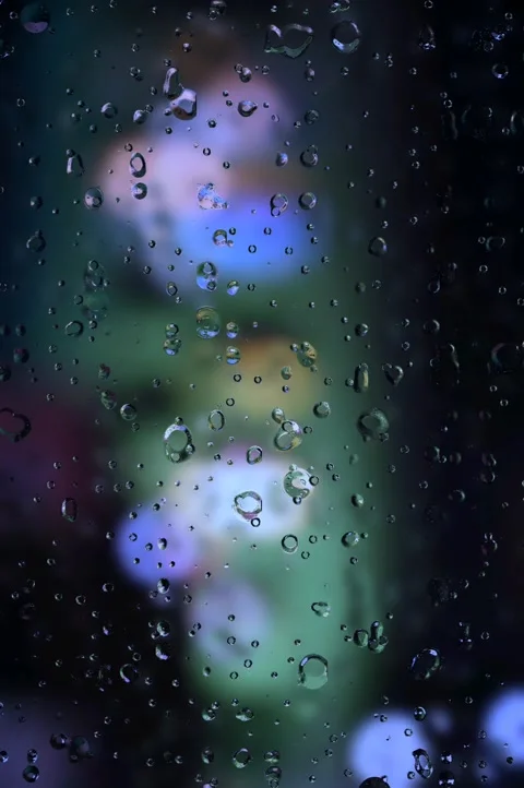 Rain drops on window. Rain drops and lights. wet glass window. rain background.  Stock Footage 302558636