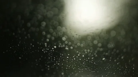 Rain drops on the window on rainy day. Green blurry background. Car window Stock Footage 73781947