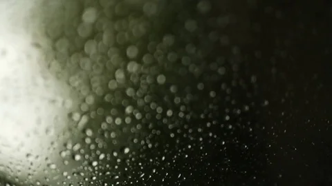 Rain drops on the window on rainy day. Green blurry background. Car window Stock Footage 73781949