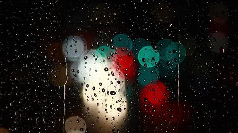 Rain drops on window surface and traffic bokeh light at night Video stock 69831662