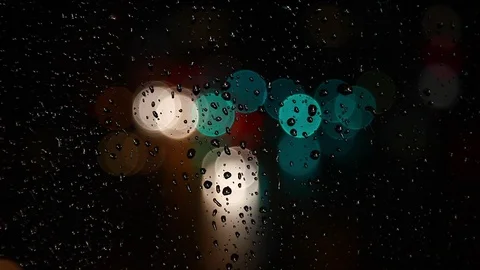 Rain drops on window surface and traffic bokeh light at night Video stock 69831747