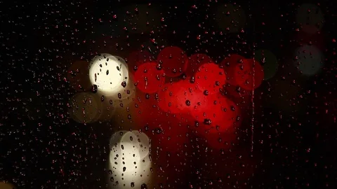 Rain drops on window surface and traffic bokeh light at night Video stock 69832644