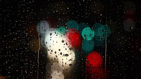 Rain drops on window surface and traffic bokeh light at night Video stock 69832716