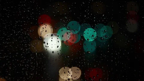 Rain drops on window surface and traffic bokeh light at night Video stock 69832860