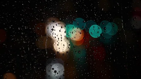 Rain drops on window surface and traffic bokeh light at night Video stock 69835428