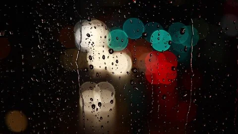 Rain drops on window surface and traffic bokeh light at night Video stock 69835473