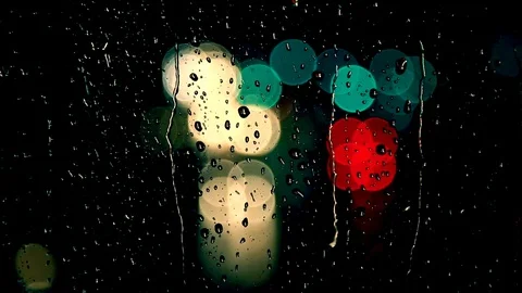 Rain drops on the window surface and traffic bokeh light Stock Footage 100465797
