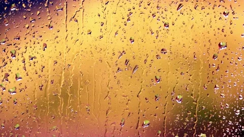 Rain drops on a window surface, golden background Stock Footage 194390148