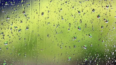 Rain drops on a window surface, green background Stock Footage 194390396