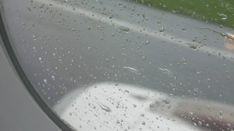 Rain drops on the window surface of the plane while moving so fast to take .. Stock Footage 254047660