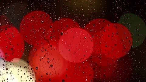 Rain drops on the window with traffic light Video stock 69850472
