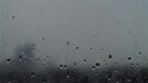 Rain drops on the window. Water drops falling from sky and wetting surface of Stock Footage 251738778