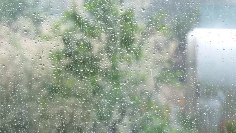 Rain drops on windows glass. Summer shower, close up Stock Footage 134474055