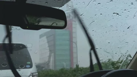Rain drops on windshield and car wipers are removing rains. Stock Footage 201182990