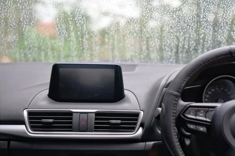 Rain drops on windshield of the car in bad weather day. Stock Photos