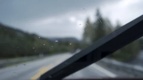 Rain drops on the windshield in driving car Stock Footage 85674461