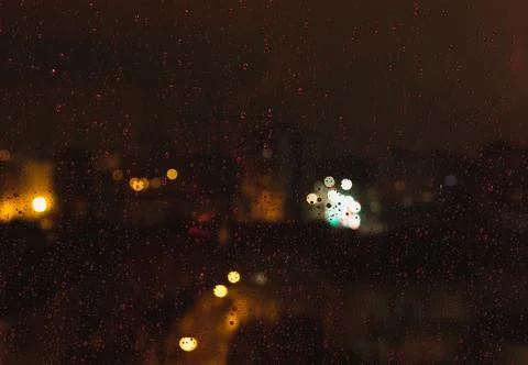 Rain effect on a window at night. winter scene Stock Photos