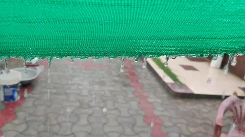 Rain fall water dripping sliding over green cloth Stock-Footage 247734560