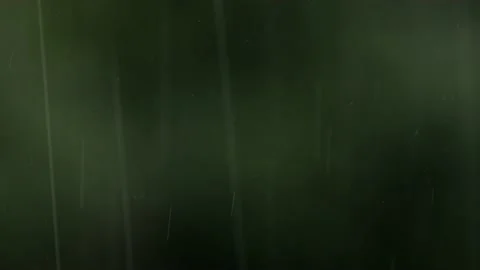 Rain Falling Against a Blurry Dark Background Stock Footage 238659422