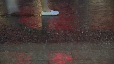 Rain falling on the asphalt peoples walking Stock Footage 94584125