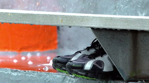 Rain falling  on athletic shoes in bleachers in slow motion Stock Footage 48669572