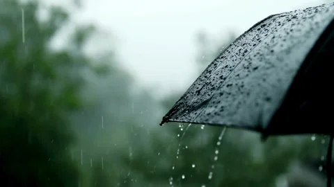 Rain falling on a black umbrella in a storm Stock Footage 334873828