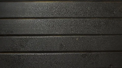 Rain falling on a black wooden table background Stock Footage 95149305