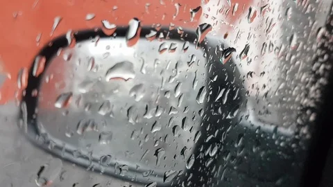 Rain falling, car mirror blurred wall background Stock Footage 106074282