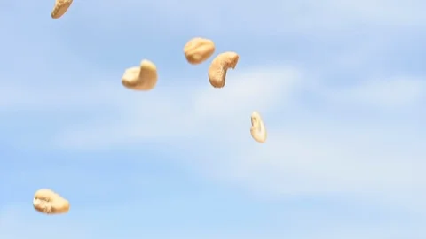 Rain of falling cashews from the sky slow motion Stock Footage 107684383