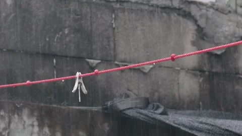 Rain Falling on Clothesline With Clothespins in Outdoor Laundry Area Stock Footage 337439008