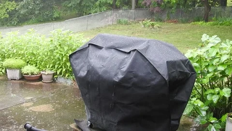Rain Falling on a Covered BBQ Grill Stock Footage 132456358