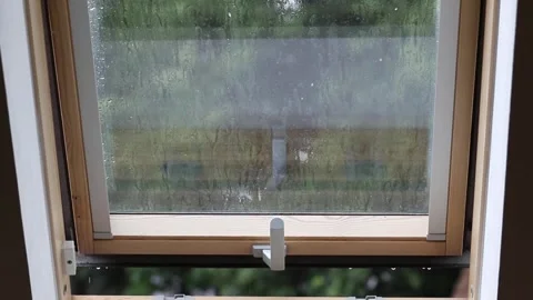 Rain falling on a dormer window Stock Footage 312560684