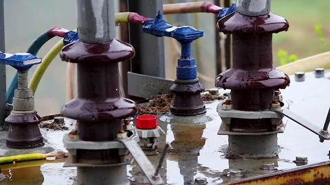 Rain falling on electrical transformer insulators during monsoon at power 库存影片 341837785