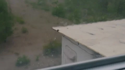Rain Falling on Exterior Unit During Heavy Storm Seen Through Window Stock Footage 335231533