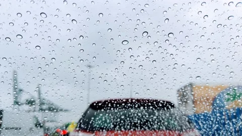 Rain falling on the front window of a car seen from inside Stock Footage 201463947