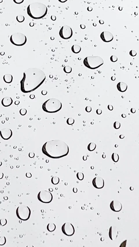 Rain falling on a glass and creating nice water drops Stock Footage 192823077