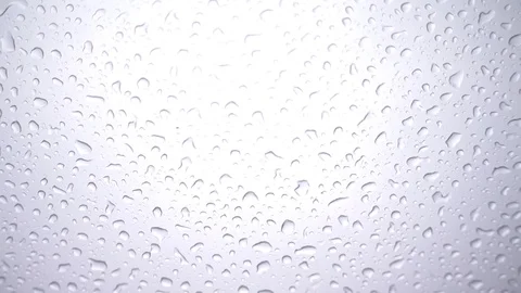 Rain falling on glass during rain storm, close up. Video stock 94841916