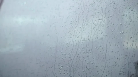 Rain falling on glass during rain storm, close up. Stock Footage 94841958