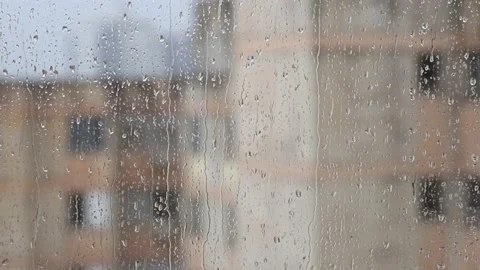 Rain falling on the glass, wet window with the rain falling outside Stock Footage 229882213