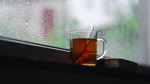 Rain falling on the glass window, flowing raindrops, the comfortable sound of Stock Footage 275882715
