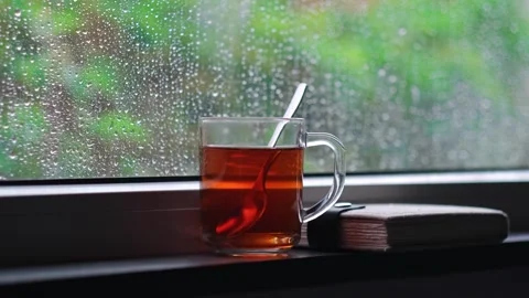 Rain falling on the glass window, flowing raindrops, the comfortable sound of Stock Footage 275882725