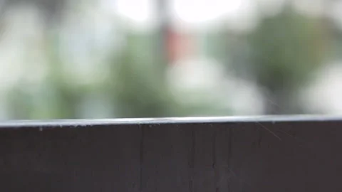 Rain falling on grey railing. Rainy weather. Rainy day. Blurred Backgorund. 库存影片 141917640