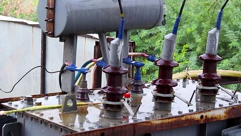 Rain Falling on High Voltage Electrical Transformer at Outdoor Power Substation Stock Footage 340018768