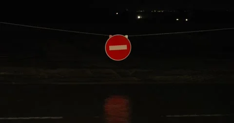 Rain falling at night in front of no entry sign Stock Footage 277387515