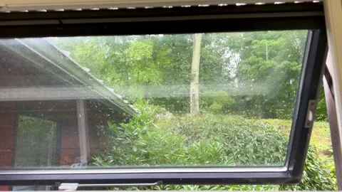 Rain Falling Outside Open Window Looking at Green Trees Stock Footage 345436519