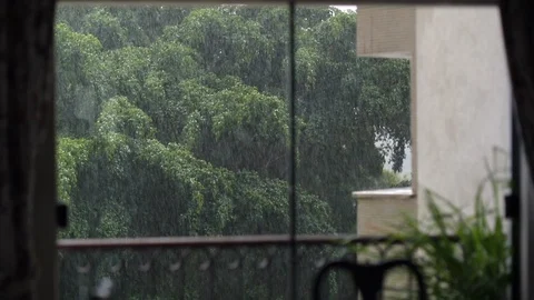 Rain falling outside seen through home window. Storm outdoors Stock Footage