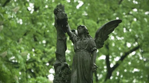 Rain falling over angel sculpture in historic Bernardine Cemetery Stock Footage 335137116
